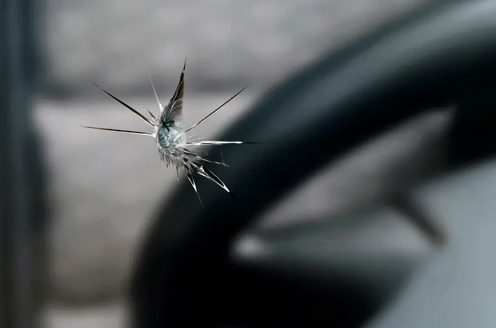 Close-up of windshield chip damage
